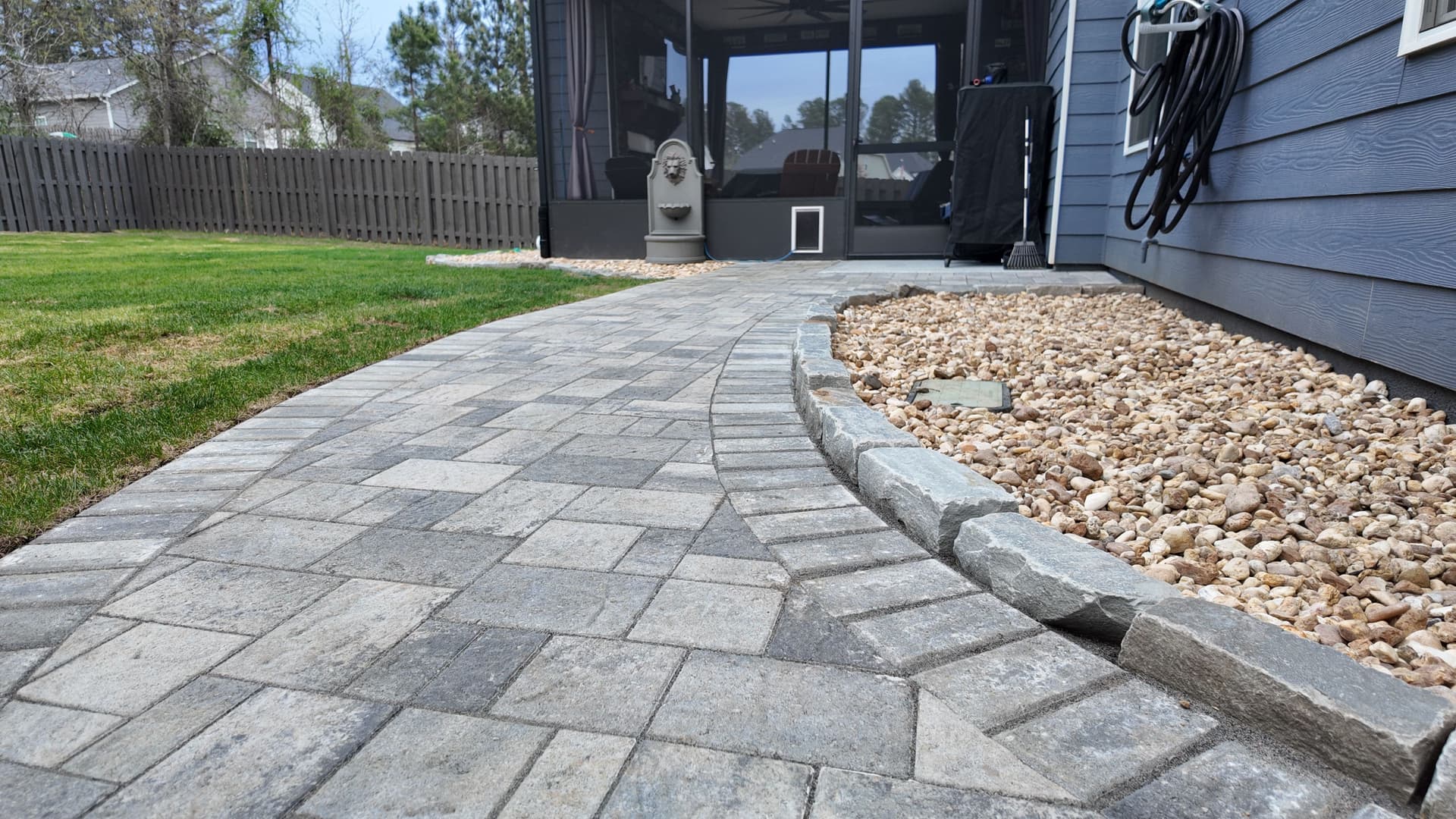 Soggy Yard Fixed With Pavers, Sod, and a Full Drainage Overhaul image